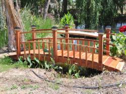Here we have a 12 foot Curved rail Half spindle bridge with Black Solar lights and 2 coats of clear sealer. 