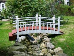 Here we have a custom 9ft bridge for uneven ground Half spindle steps on one end .Painted white&red. located in Monson,MA.