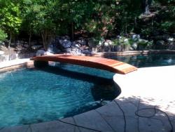 Here we have a converted swimming pool to a Big Koi pond with a 18foot plank bridge. Located in Calabasas,CA.